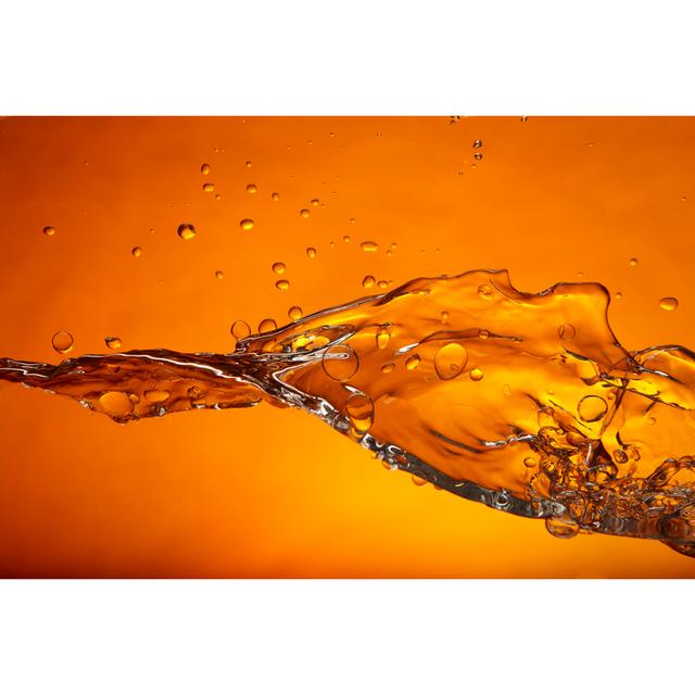 Water Splash On An Orange Background by Hirkophoto - Print Wall Art Production Network Size: 51cm H x 76cm W x 3.8cm D on Productcaster.