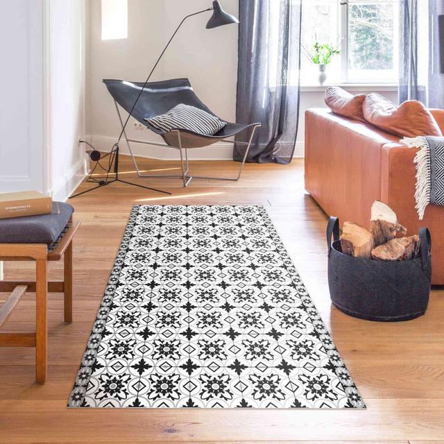 This black vinyl rug features a geometric mix of tiles East Urban Home Rug Size: Rectangular 130 x 260cm on Productcaster.