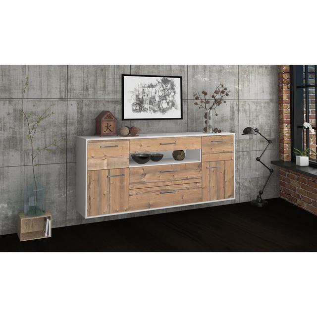 The Barri sideboard is features metal handles. It measures 180cm x 79cm x 35cm Brayden Studio Colour: Pine/White on Productcaster.