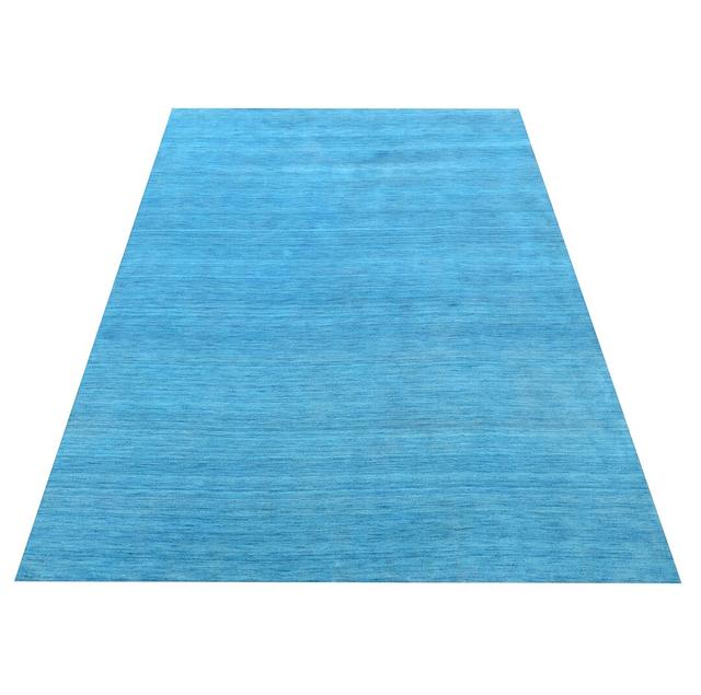 Astral Solid Colour Hand Loomed Teal Area Rug 17 Stories Size: Rectangular 60 x 90cm on Productcaster.