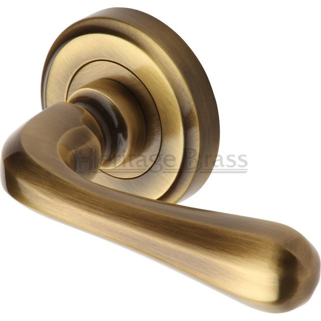 Diamond Heritage Door Handle Lever Latch on Round Rose Charlbury Design (Set of 2) Heritage Brass Finish: Antique Brass on Productcaster.