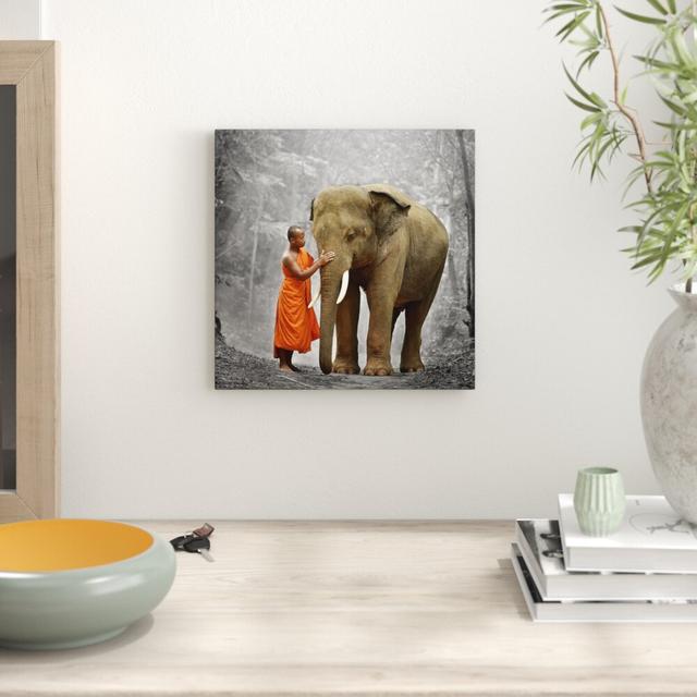 Leinwandbild Beautiful Elephant with Monk East Urban Home Größe: 60 cm H x 60 cm B on Productcaster.