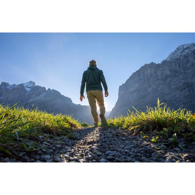 Man Hikes Along Grassy Mountain by AscentXmedia - No Frame Print on Canvas 17 Stories Size: 81cm H x 122cm W on Productcaster.