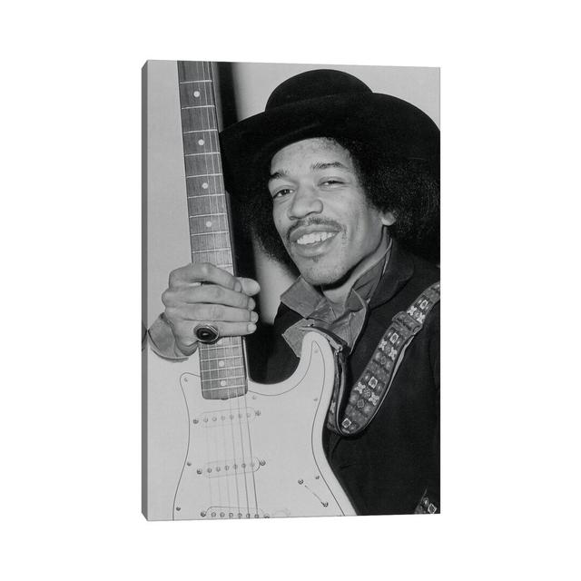 A Smiling Jimi Hendrix Holding His Guitar by Radio Days - Photograph Print on Canvas George Oliver Format: Wrapped Canvas, Size: 30.48cm H x 20.32cm W on Productcaster.