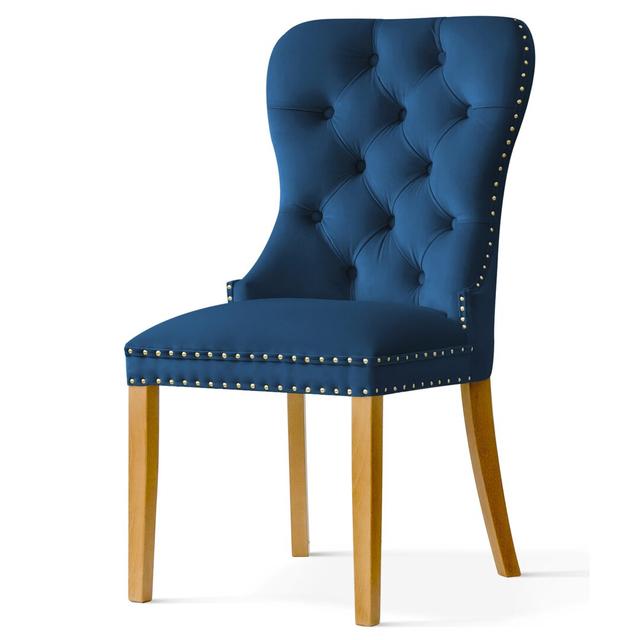 Ashlyn Dining Chair In Navy Blue Velvet Fabric With Golden Sturd And Knocker With Wooden Legs In Oak Colour Ophelia & Co. Upholstery Colour: Navy, Nai on Productcaster.