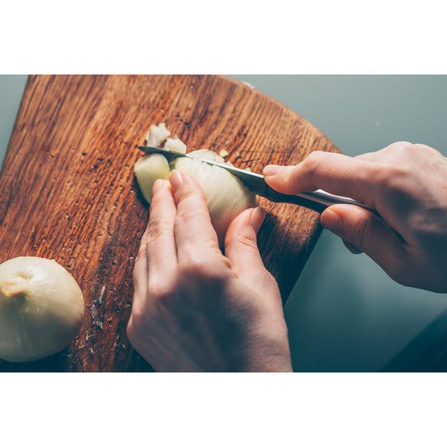 The Cook Cuts the Onion on a Cutting Board - Wrapped Canvas Photograph Ebern Designs Size: 20cm H x 30cm W x 3.8cm D on Productcaster.