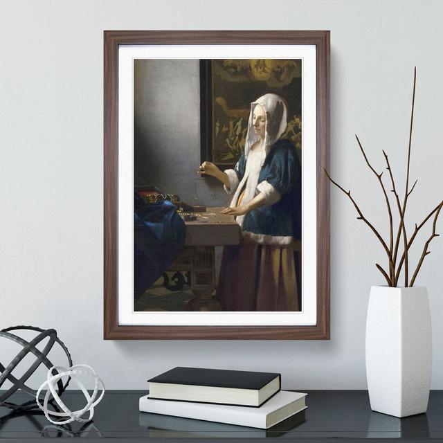 Woman Holding a Balance by Johannes Vermeer - Picture Frame Painting East Urban Home Size: 65cm H x 48cm W x 2cm D, Frame Option: Walnut Framed on Productcaster.