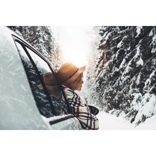 Beautiful Woman Traveler Wearing Hat and Scarf Leant Out of the Car Window and Enjoying of Winter Road and Forest Young Hipster Traveling by Car in Wi on Productcaster.