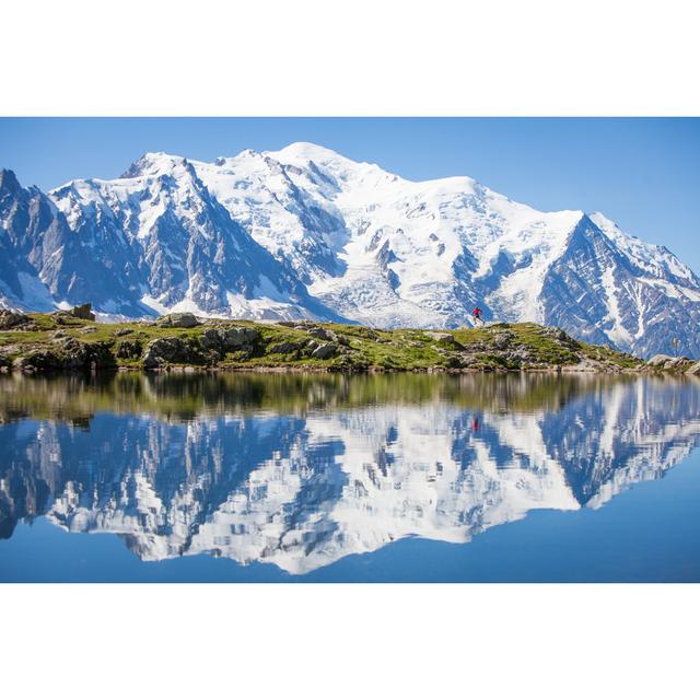 Reflection on crystal clear alpine lake, running man Alpen Home Size: 61cm H x 91cm W on Productcaster.