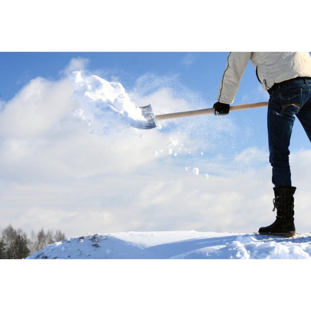 Man Removing Snow by Zest_Marina - Wrapped Canvas Photograph Latitude Run Size: 61cm H x 91cm W on Productcaster.