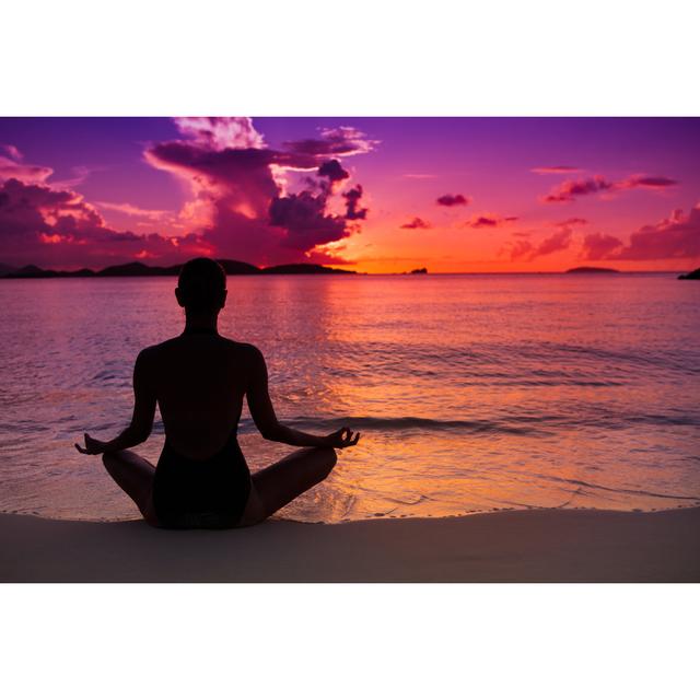 woman meditating in lotus pose on a beach at sunset House of Hampton Size: 50cm H x 75cm W on Productcaster.