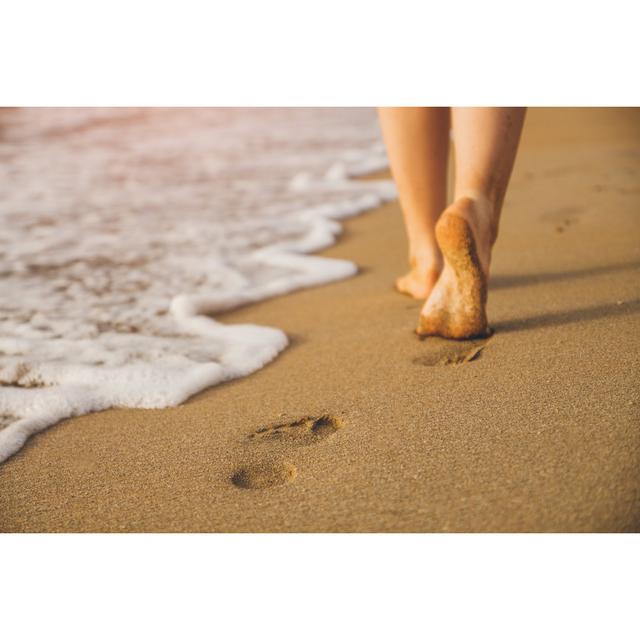 Woman Walking On Sand Beach Leaving Footprints In The Sand Highland Dunes Size: 81cm H x 122cm W on Productcaster.