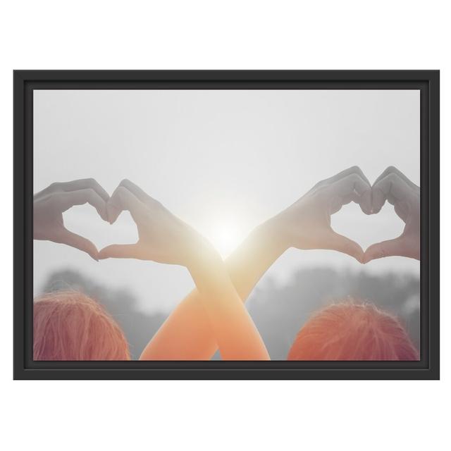 Two Girls Making a Heart Floater Frame Graphic Art Print on Paper East Urban Home Größe: 40 cm H x 55 cm B x 2,4 cm T, Farbe: Orange on Productcaster.