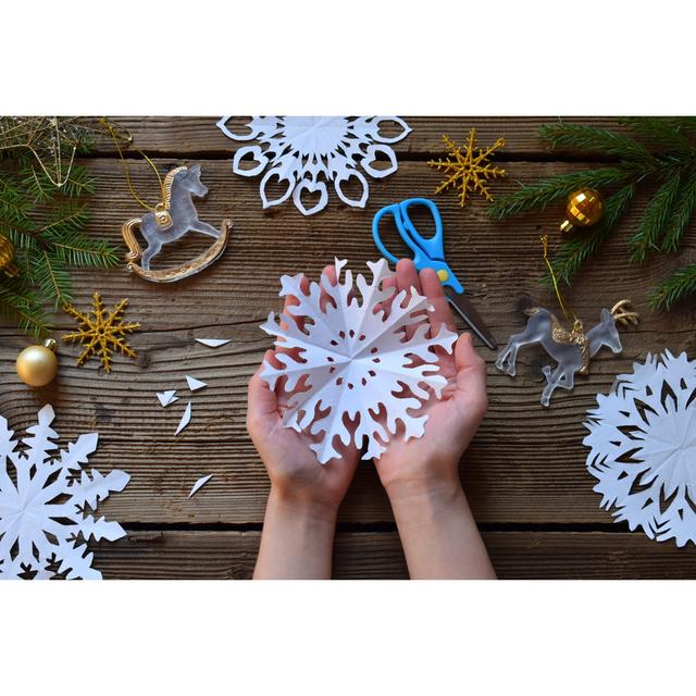 Child with Paper Snowflakes - Wrapped Canvas Photograph Ebern Designs Size: 81cm H x 122cm W x 3.8cm D on Productcaster.