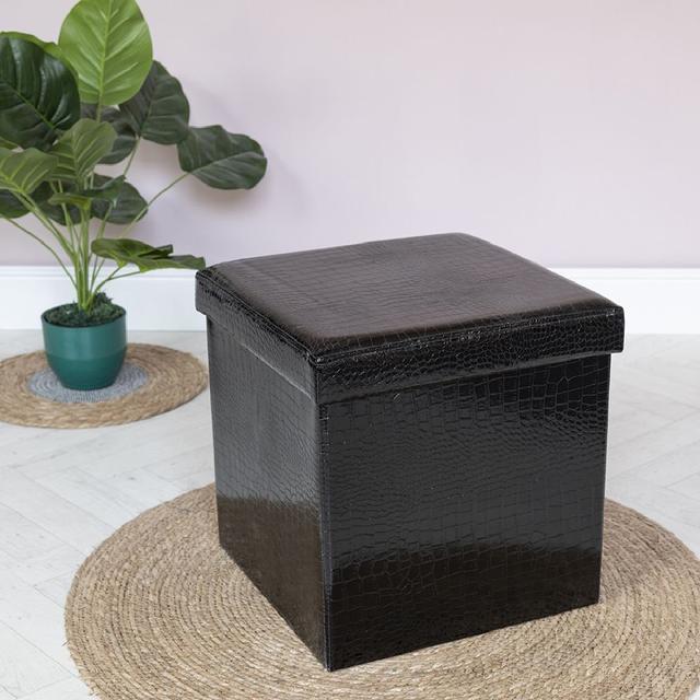 Hocker Malakai mit Stauraum ScanMod Design Polsterfarbe: Schwarz on Productcaster.