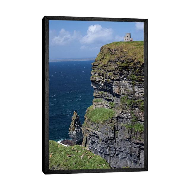 Scenic Cliffs Of Moher And O'brien's Tower Under A Blue Sky And White Puffy Clouds With Waves Of The Atlantic Ocean Below by Marilyn Parver - Print on on Productcaster.