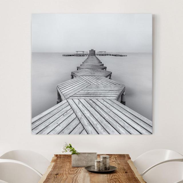 Leinwandbild - Hölzerner Pier Und Schwarz-Weiß Haus am Meer on Productcaster.