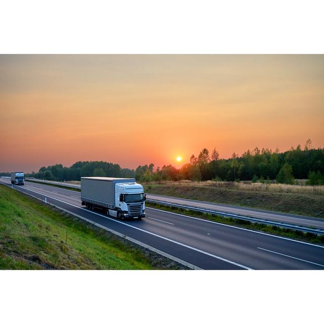 White Trucks Driving on the Asphalt Highway at Sunset - Wrapped Canvas Photograph Ebern Designs Size: 30cm H x 46cm W on Productcaster.