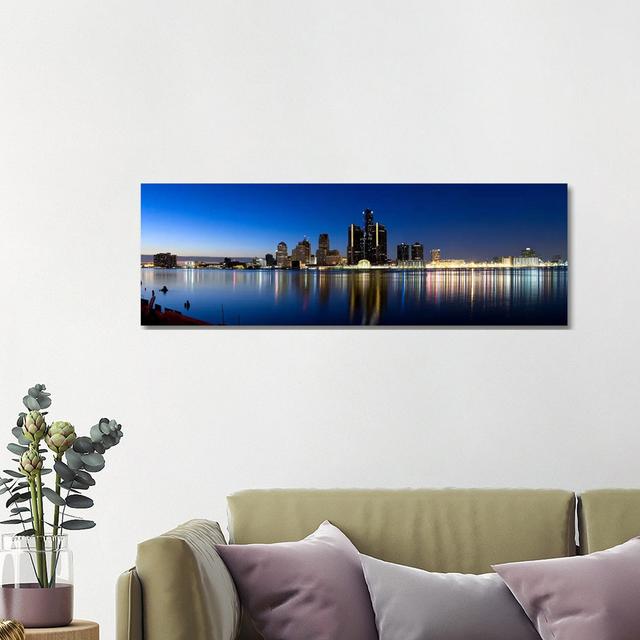 Buildings In A City Lit Up At Dusk, Detroit River, Detroit, Michigan, USA - Wrapped Canvas Panoramic Print Ebern Designs Size: 40.64cm H x 121.92cm W on Productcaster.