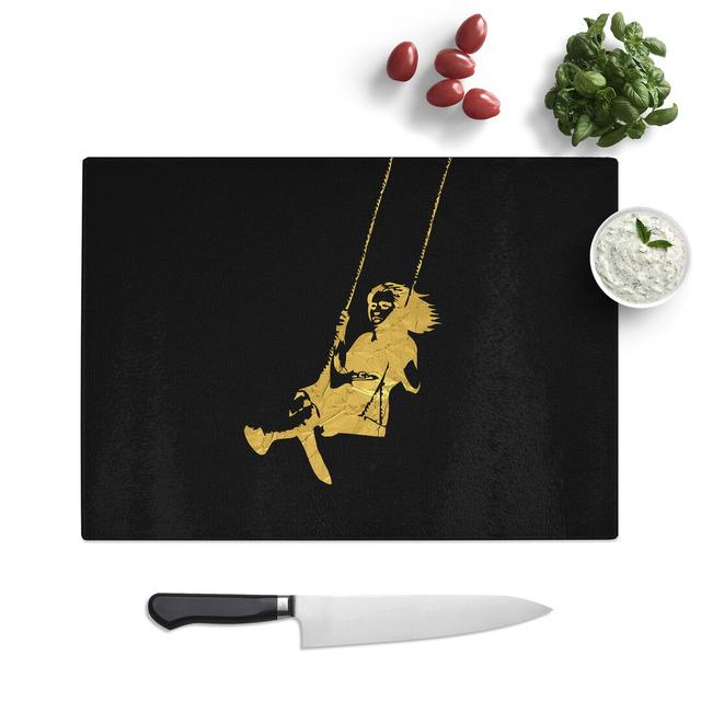 Banksy in Gold Girl on Swing Chopping Board East Urban Home Size: 0.4cm H x 20cm W x 28.5cm L on Productcaster.