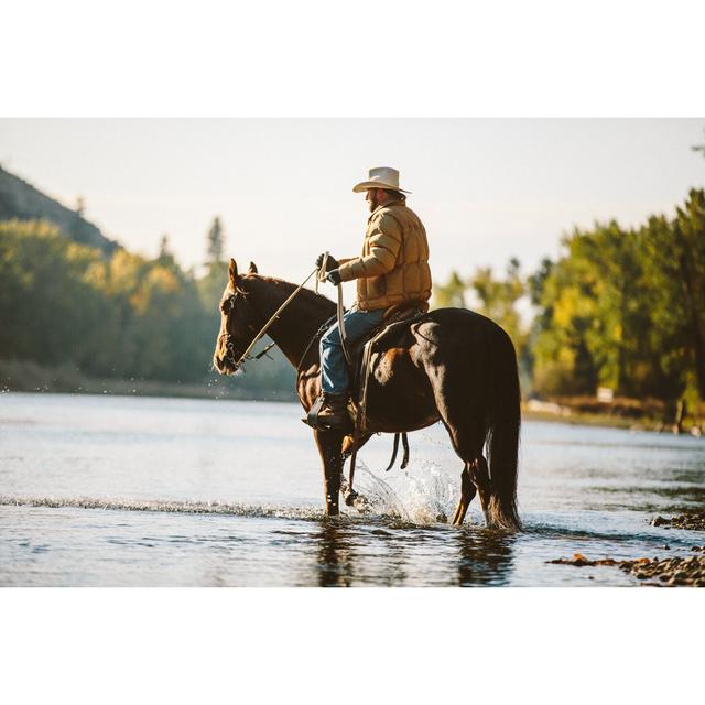 Horse And Male Rider Wade In Water Along River Bank by Epicurean - No Frame Print on Canvas Natur Pur Size: 81cm H x 122cm W on Productcaster.