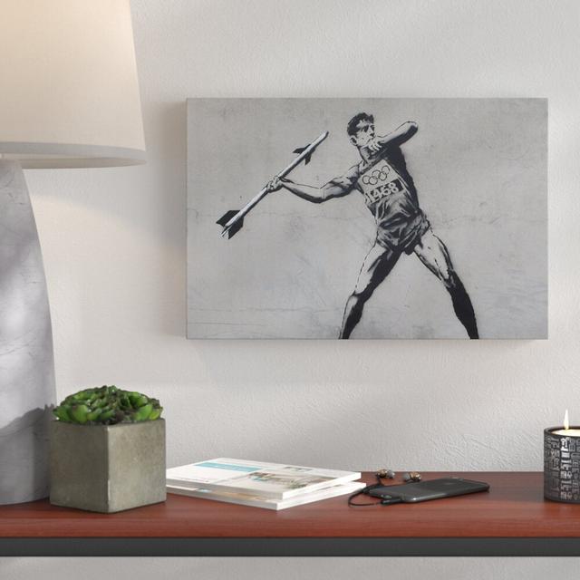 Javelin Thrower by Banksy - Wrapped Canvas Graphic Art Print East Urban Home Size: 51cm H x 76cm W x 4cm D on Productcaster.