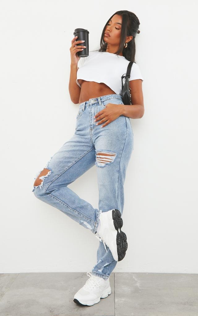 PRETTYLITTLETHING Light Blue Wash Open Knee Ripped Hem Mom Jeans on Productcaster.