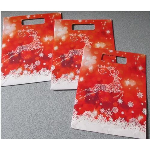 Trois jolis sachets pour cadeaux en papier brillant-fond rouge avec... on Productcaster.